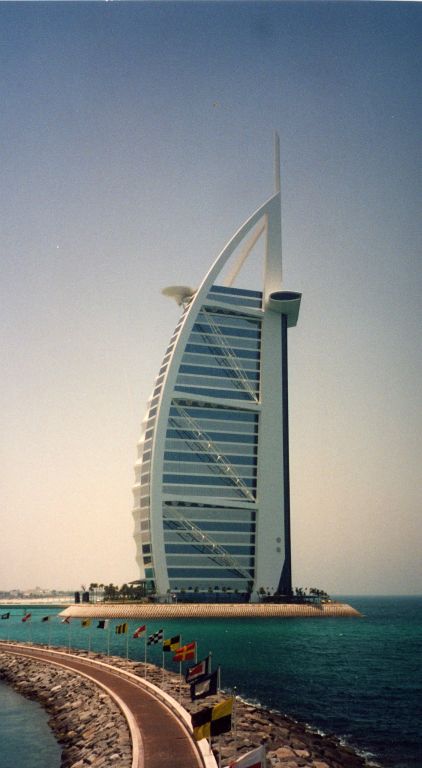 The Burj Al Arab Hotel as seen from the harbour wall at the Jumeirah Beach Hotel.  The wing-like feature you can see sticking out of the seaward side of the building is the Al Muntana Skyview Restaurant.